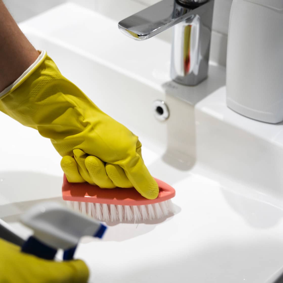 Professional house cleaner sanitizing kitchen in Carrboro, NC
