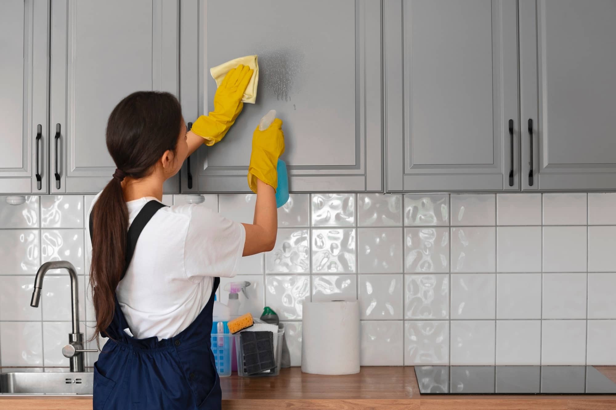 Professional house cleaner disinfecting kitchen in Orange County, NC